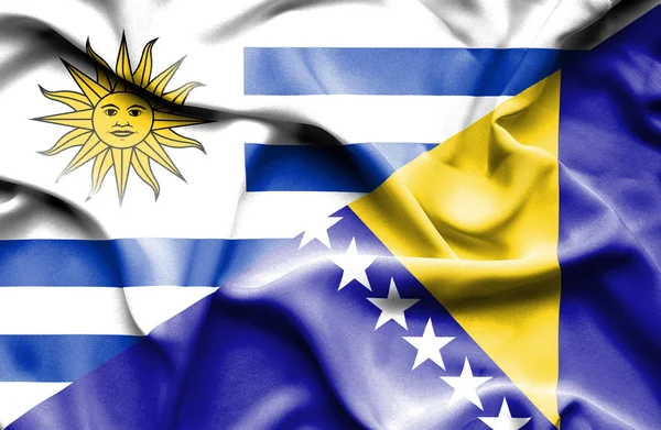 Waving flag of Bosnia and Herzegovina and Uruguay — Stock Photo, Image