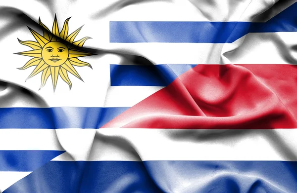 Waving flag of Costa Rica and Uruguay — Stockfoto
