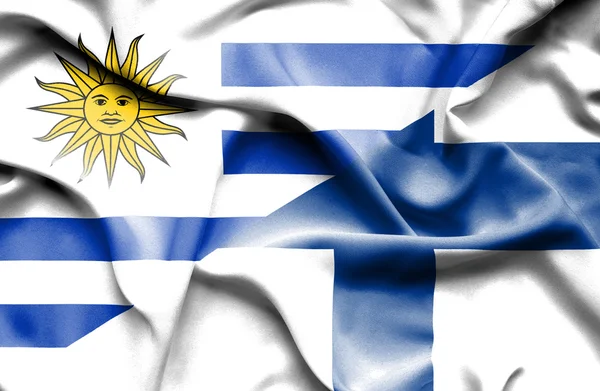 Waving flag of Finland and Uruguay — ストック写真