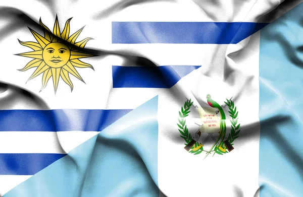 Waving flag of Guatemala and  Uruguay — Stok fotoğraf
