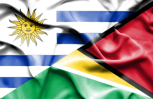 Waving flag of Guyana and Uruguay — Zdjęcie stockowe