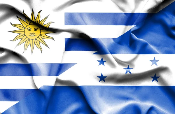 Waving flag of Honduras and Uruguay — стокове фото