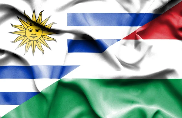 Waving flag of Hungary and Uruguay — Zdjęcie stockowe