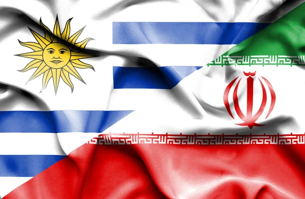 Waving flag of Iran and Uruguay — Zdjęcie stockowe