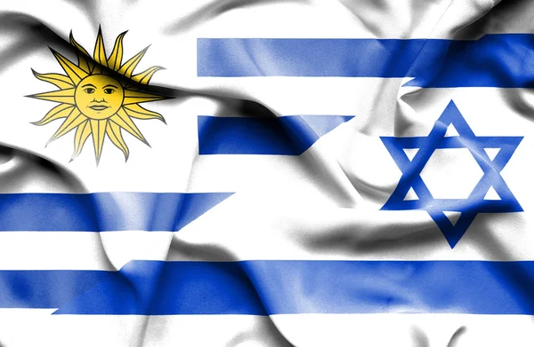 Waving flag of Israel and Uruguay — Stock Photo, Image