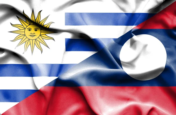 Flagge von Laos und Uruguay schwenken — Stockfoto