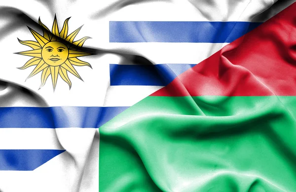 Machać flaga Madagaskaru i Urugwaju — Zdjęcie stockowe