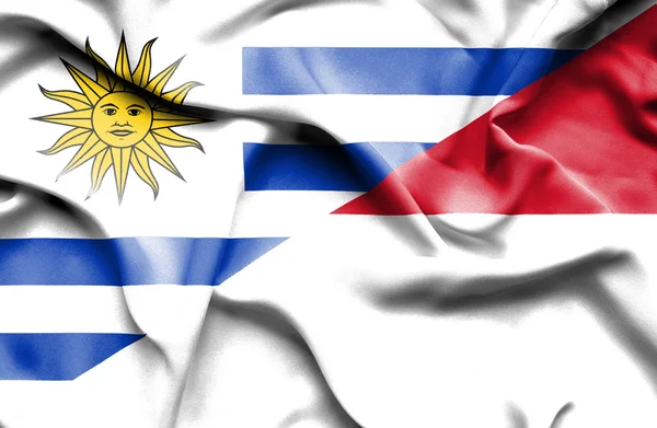 Flagge von Monaco und Uruguay schwenken — Stockfoto
