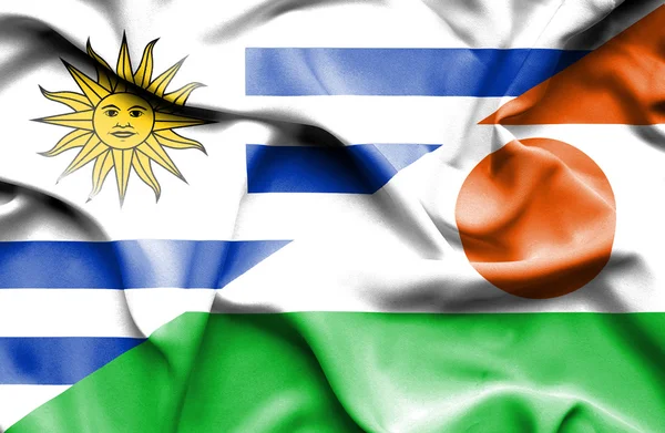 Waving flag of Niger and Uruguay — Stock Photo, Image