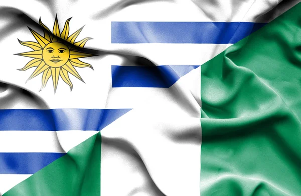 Waving flag of Nigeria and Uruguay — Stock Photo, Image