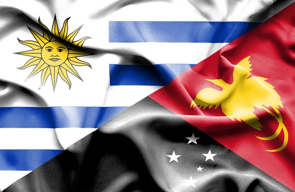 Machać flaga Papui-Nowej Gwinei i Urugwaju — Zdjęcie stockowe