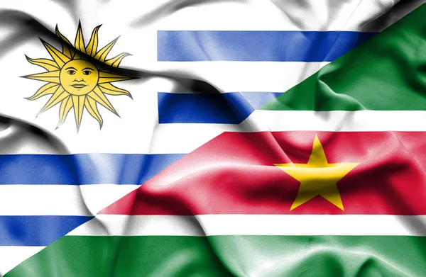 Flagge von Surinam und Uruguay schwenken — Stockfoto