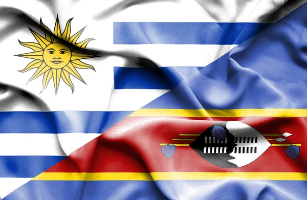 Waving flag of Swazliand and Uruguay — Stockfoto