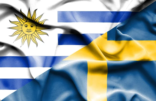 Waving flag of Sweden and Uruguay — Stock Photo, Image
