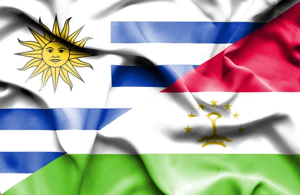 Waving flag of Tajikistan and Uruguay — Zdjęcie stockowe