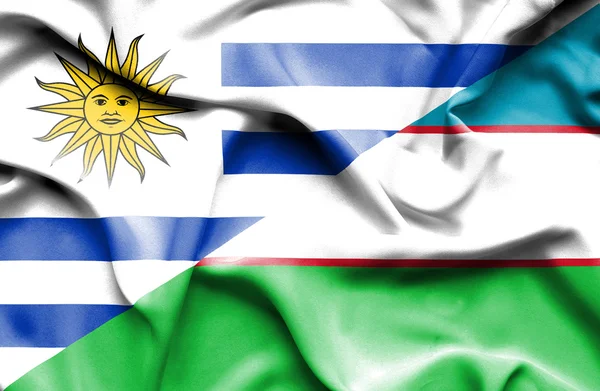 Waving flag of Uzbekistan and Uruguay — Zdjęcie stockowe
