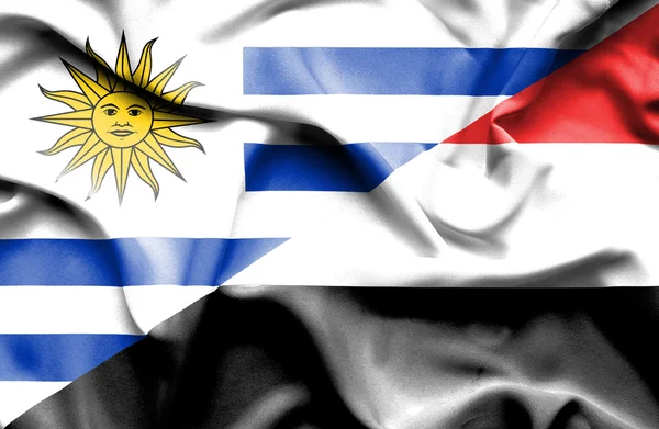 Waving flag of Yemen and Uruguay — Stock Photo, Image