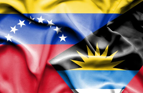 Waving flag of Antigua and Barbuda and Venezuela — Stock fotografie