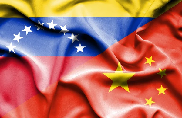 Waving flag of China and Venezuela — Stockfoto