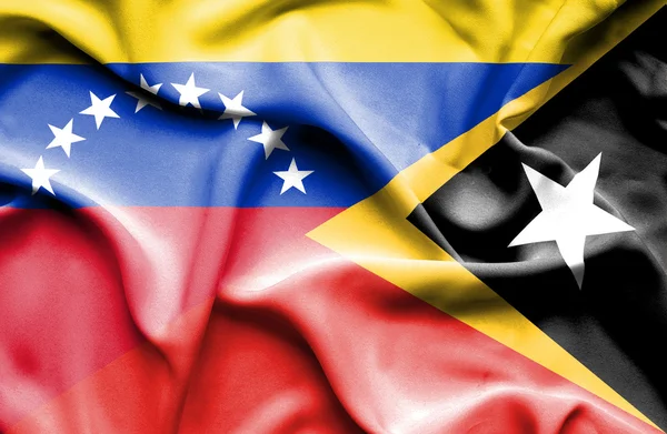 Waving flag of East Timor and Venezuela — Stockfoto