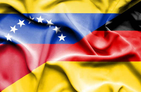 Waving flag of Germany and Venezuela — Stockfoto