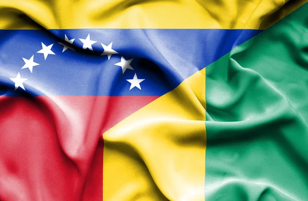 Waving flag of Guinea and Venezuela — Stockfoto