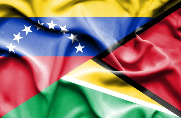 Waving flag of Guyana and Venezuela — Stockfoto