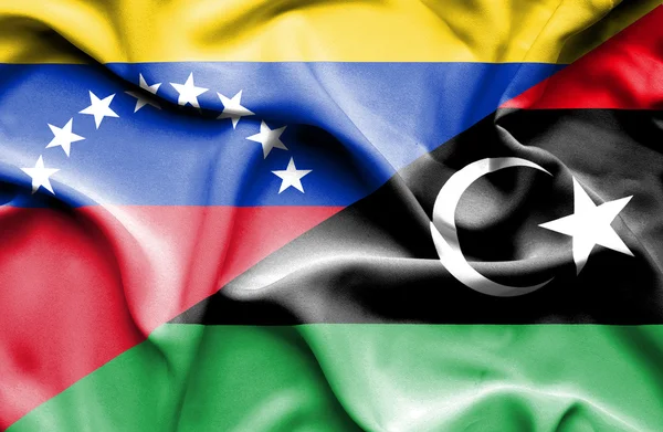 Waving flag of Libya and Venezuela — Stock fotografie