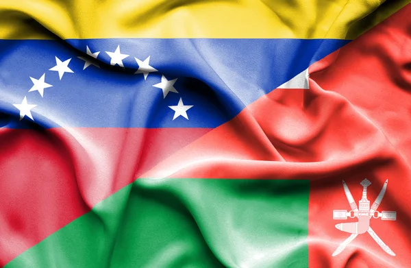 Waving flag of Oman and Venezuela — Stock Photo, Image