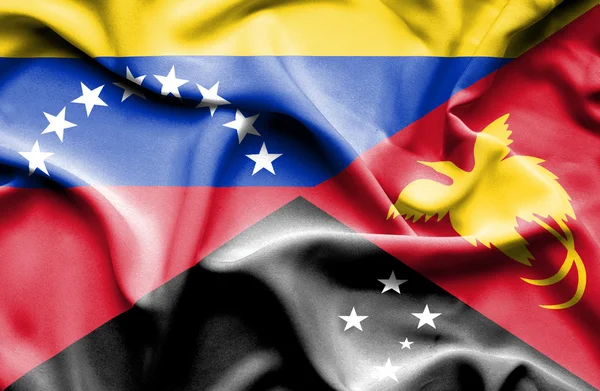 Papua nya guinea och venezuela viftande flagga — Stockfoto
