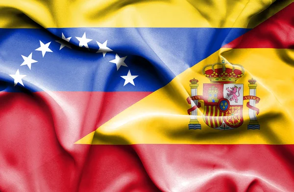 Waving flag of Spain and Venezuela — Stockfoto