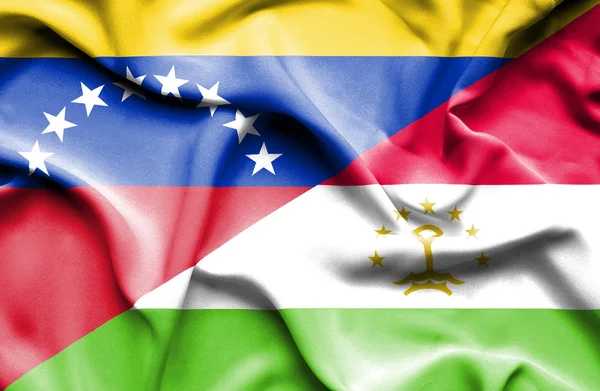 Waving flag of Tajikistan and Venezuela — Stockfoto