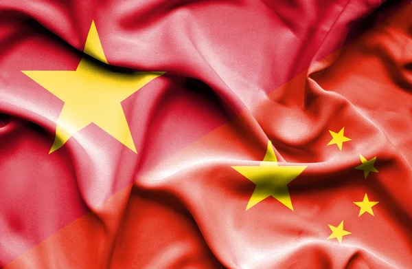 Waving flag of China and Vietnam — Stock fotografie