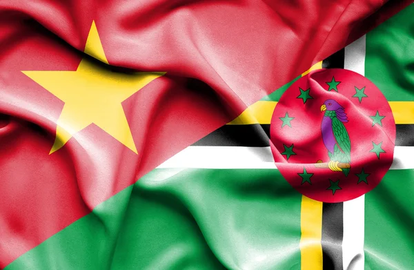 Waving flag of Dominica and Vietnam — Stock fotografie