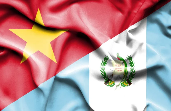 Waving flag of Guatemala and Vietnam — Stock Photo, Image