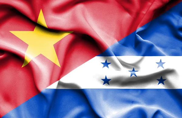 Waving flag of Honduras and Vietnam — Stock Photo, Image