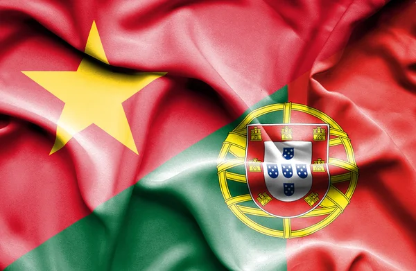 Waving flag of Portugal and Vietnam — Stockfoto