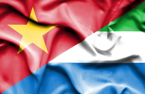 Waving flag of Sierra Leone and Vietnam — Stockfoto