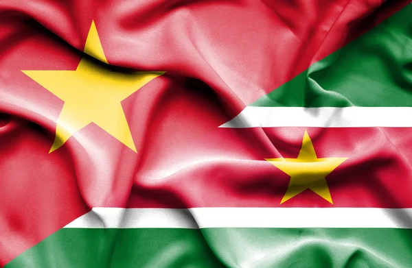 Bandeira ondulada do Suriname e Vietnã — Fotografia de Stock