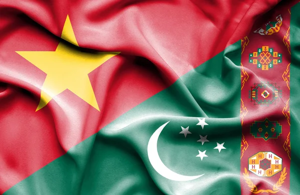 Waving flag of Turkmenistan and Vietnam — Stockfoto