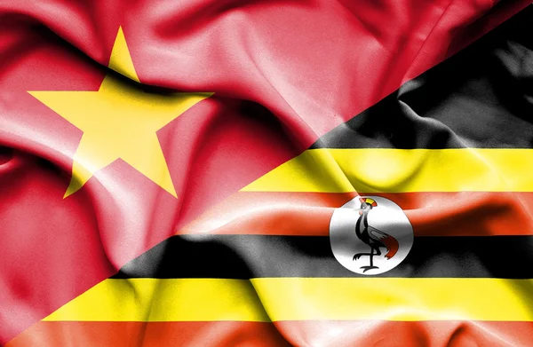 Waving flag of Uganda and Vietnam — Stok fotoğraf