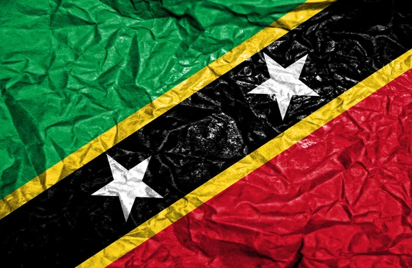 St Kitts och Nevis vintage flagga på gamla skrynkligt papper bakgrund — Stockfoto