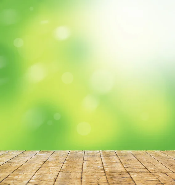 Verde bokeh luminoso e la luce del sole contro pavimento in legno - Natura ba — Foto Stock