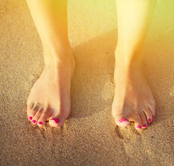 海滩旅行-女人在留下脚印在沙滩上行走 免版税图库照片