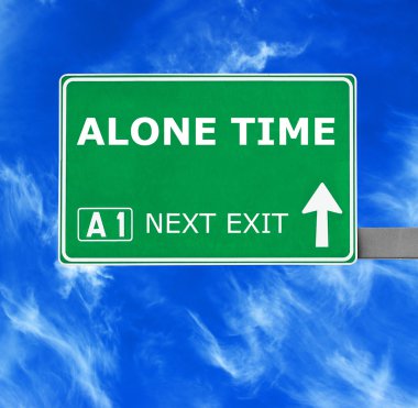 ALONE TIME road sign against clear blue sky clipart