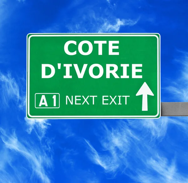 COTE D'IVORIE road sign against clear blue sky — Stock Photo, Image