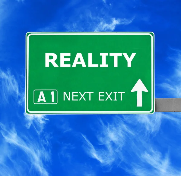 REALITY road sign against clear blue sky — Stock Photo, Image