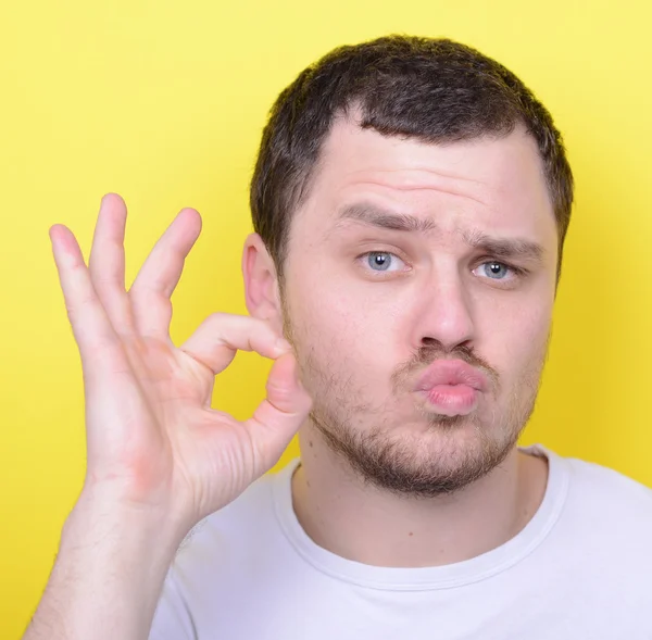 Portrait of funny man showing OK gesture with hands against yell — Stok fotoğraf