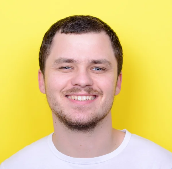 Portrait of handsome man smiling against yelllow background — Stock Photo, Image