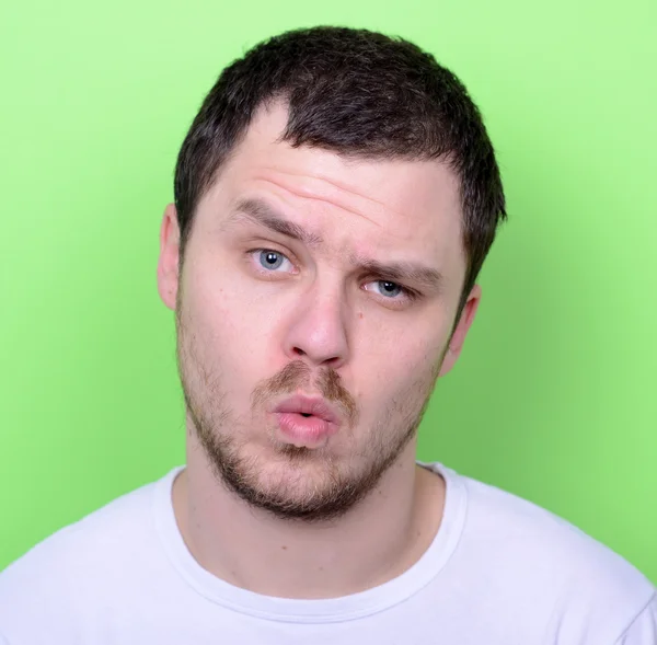 Portrait of man with funny face against green background — Stock Photo, Image